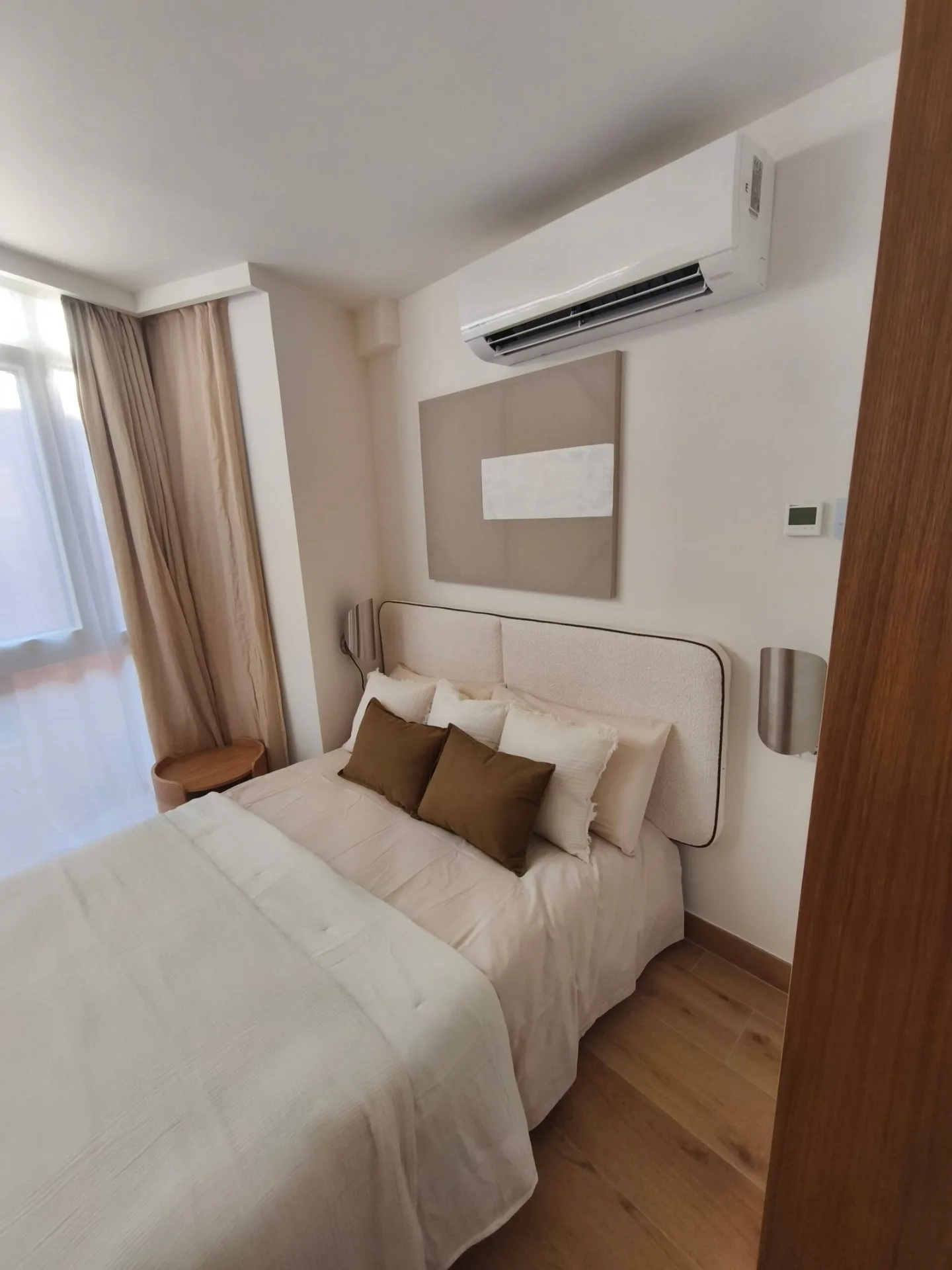 Dormitorio con cama, escritorio y aire acondicionado